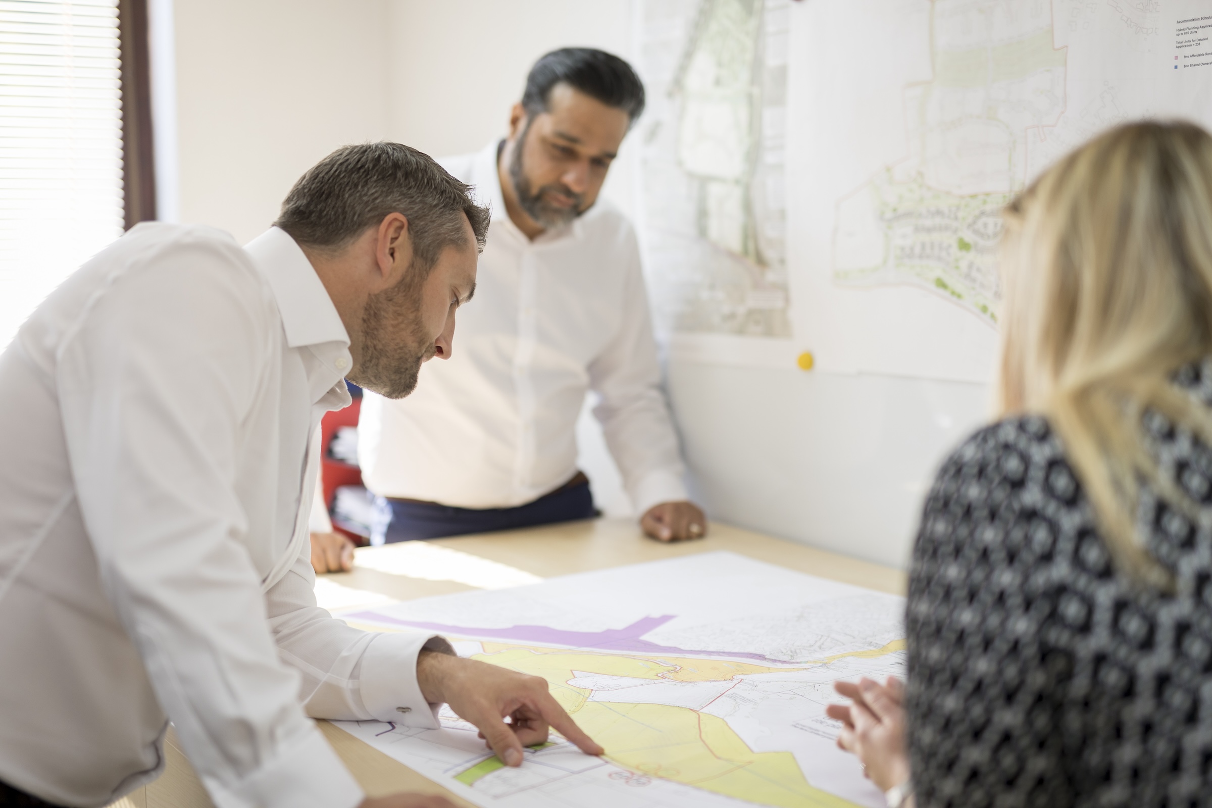 Martin Grant Land team studying a site plan